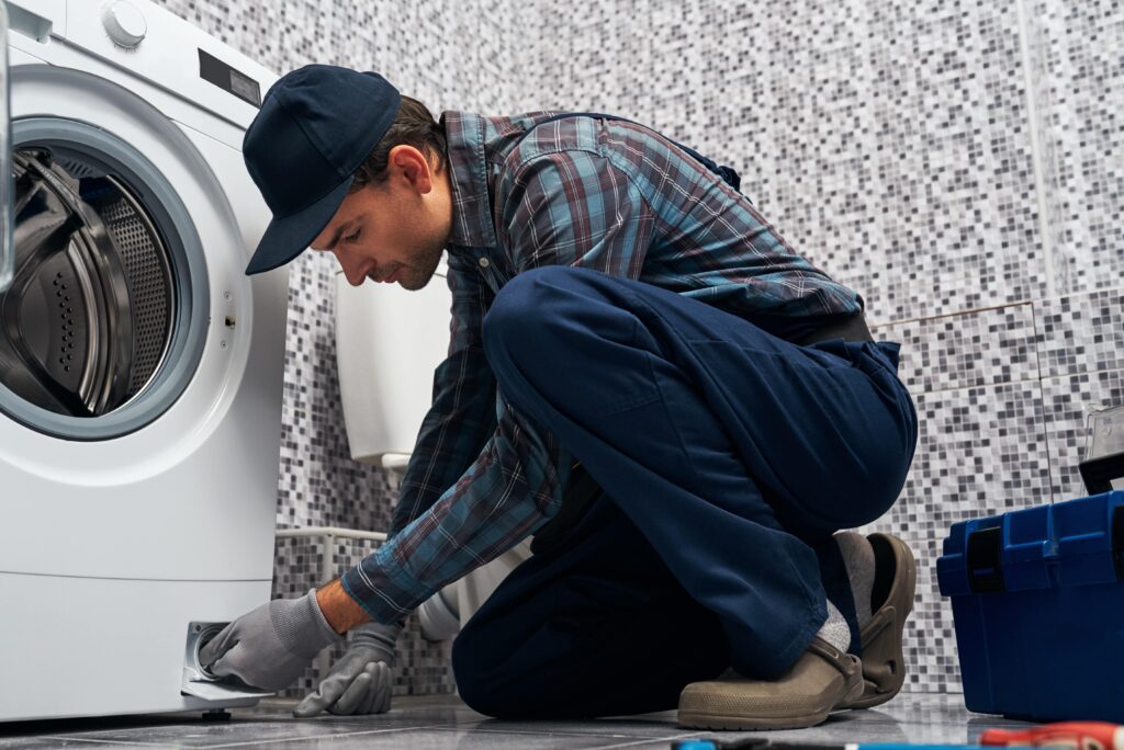 Plumber working on a washing machine