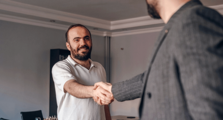 two men shaking hands because they made a sale