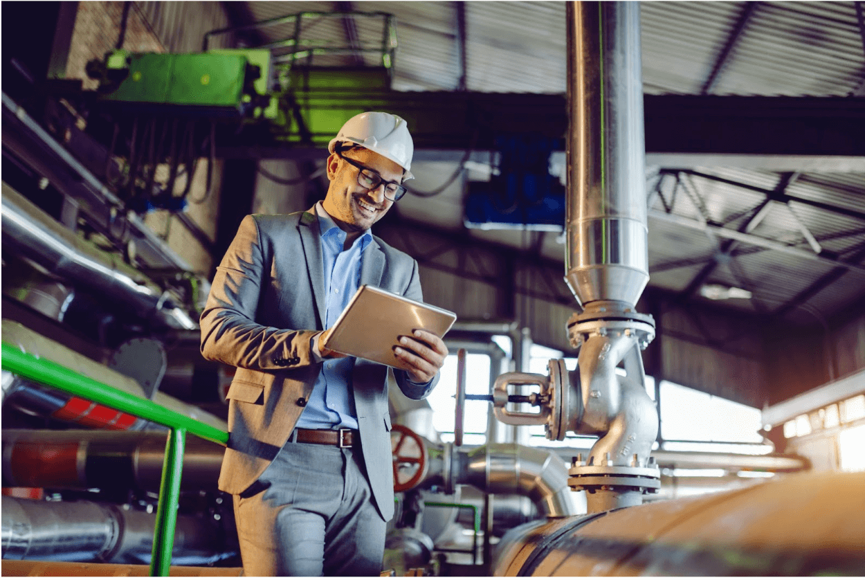 A worker with a clipboard in a manufacturing plant.