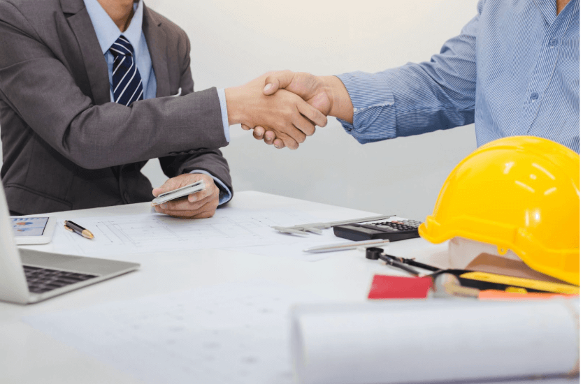 Business owners shaking hands after a successful business transaction.